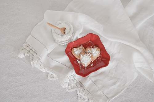 overhead view flat lay photography of heart-shaped cookies on red plate red